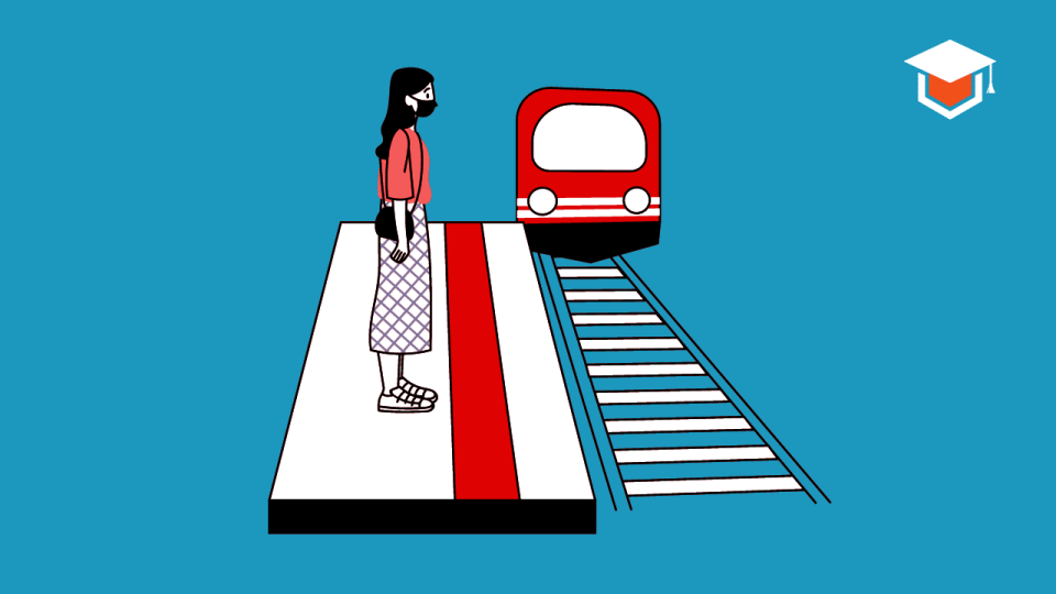 A girl is waiting for a train in a railway station